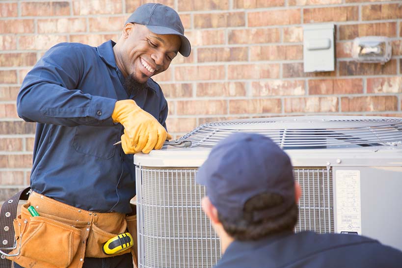 HVAC Feature Photo Man Repairing AC Unit